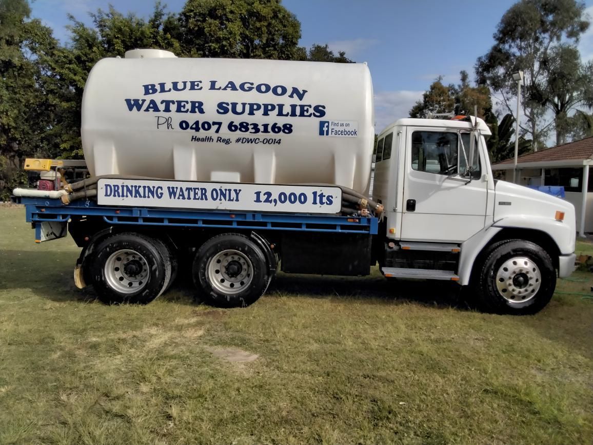 A Blue Lagoon Water Supplies Truck Is Parked In The Grass — Blue Lagoon Water Supplies In Urangan, QLD
