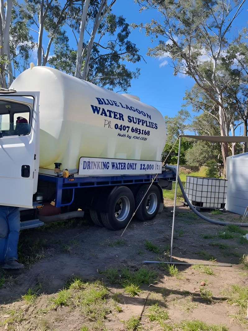 A Water Supply Truck Is Parked In A Dirt Field — Blue Lagoon Water Supplies In Urangan, QLD