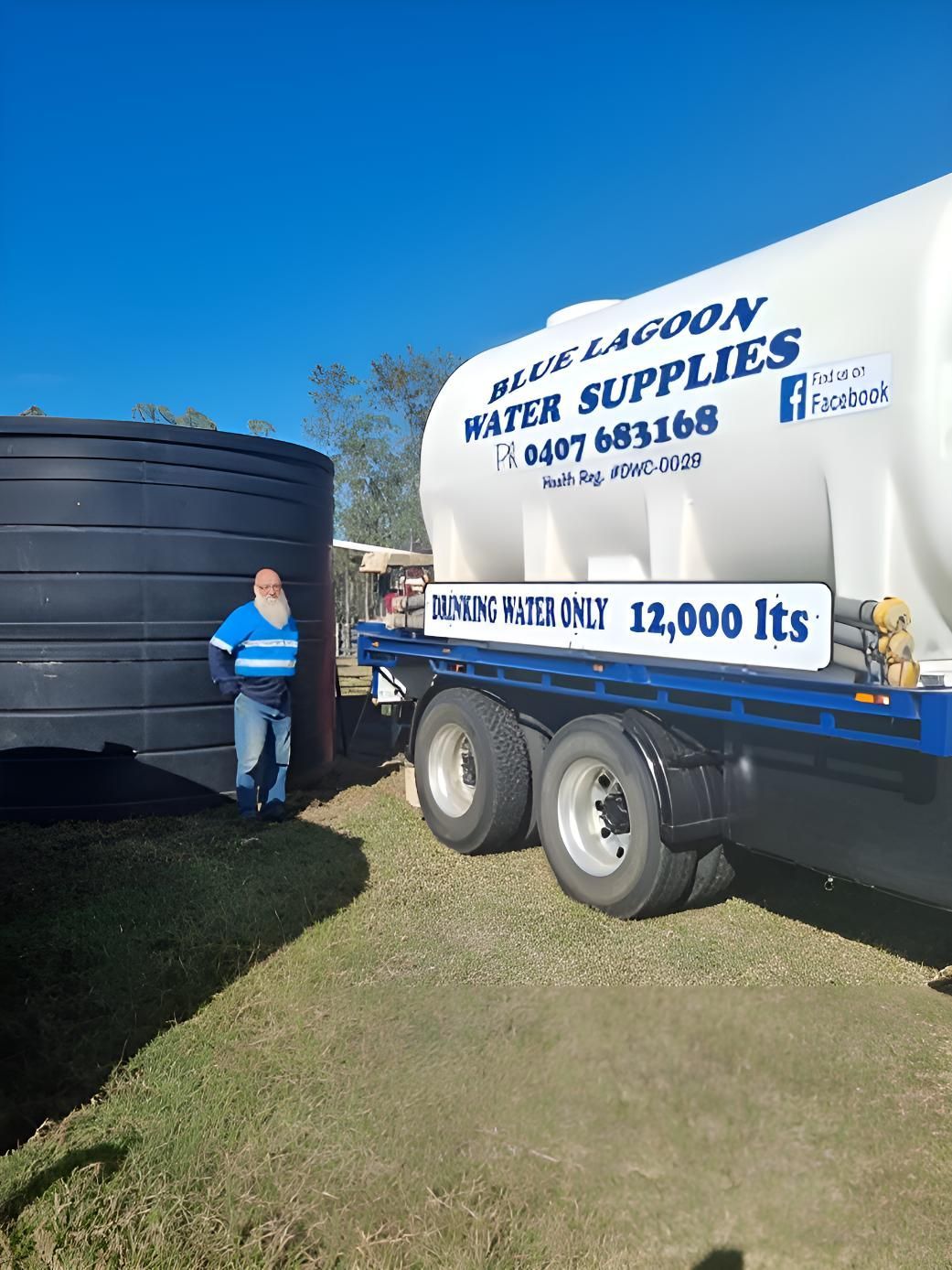 A Man Is Standing Next To A Water Supply Truck — Blue Lagoon Water Supplies In Urangan, QLD
