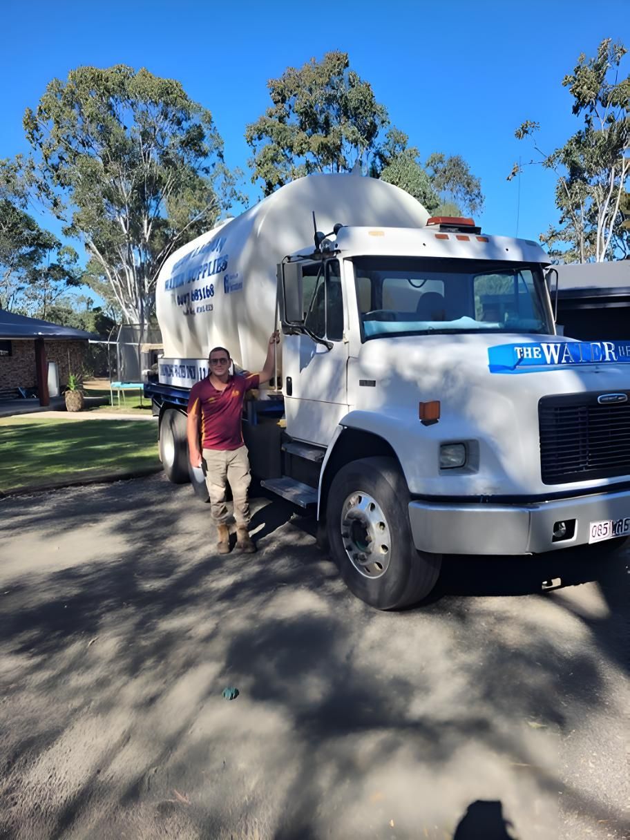 A Man Standing Next To A Water Truck — Blue Lagoon Water Supplies In Urangan, QLD
