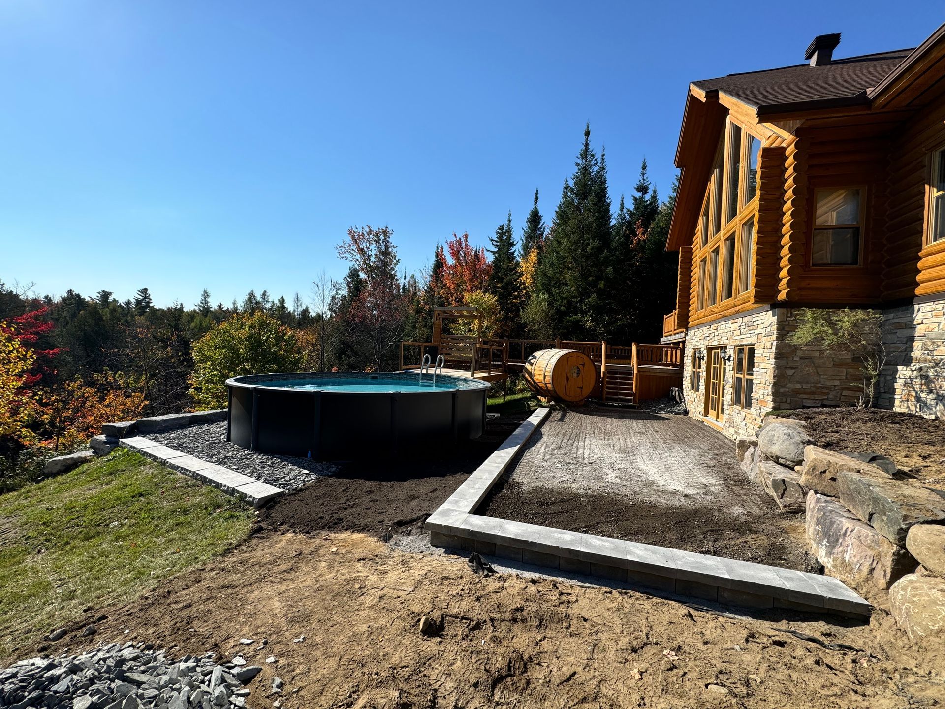 Une cabane en rondins avec un bain à remous devant.