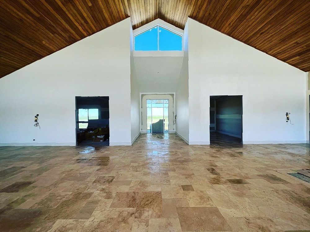 A Large Empty Room With a Vaulted Ceiling — S & S Tiling and Rendering in Cobar, NSW