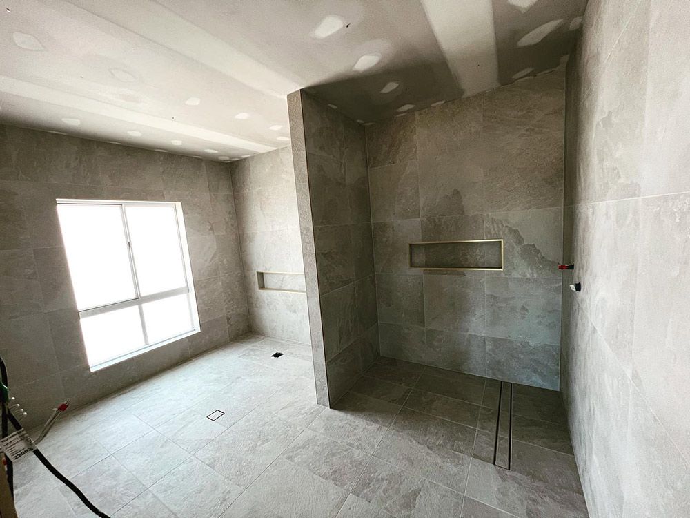 A Bathroom With a Walk-in Shower and a Window — S & S Tiling and Rendering in Dubbo, NSW