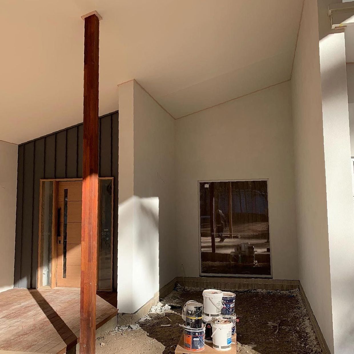A Building Under Construction With a Wooden Pole in the Middle of It — S & S Tiling and Rendering in Coonamble, NSW