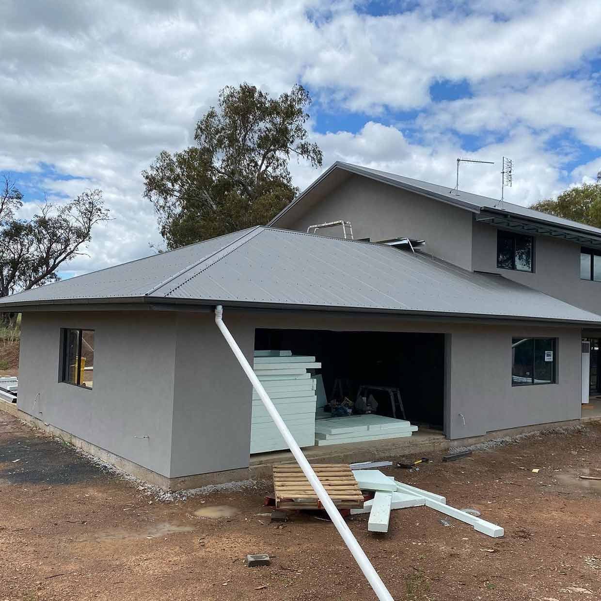 A Large House With a Gray Roof is Being Built — S & S Tiling and Rendering in Mudgee, NSW