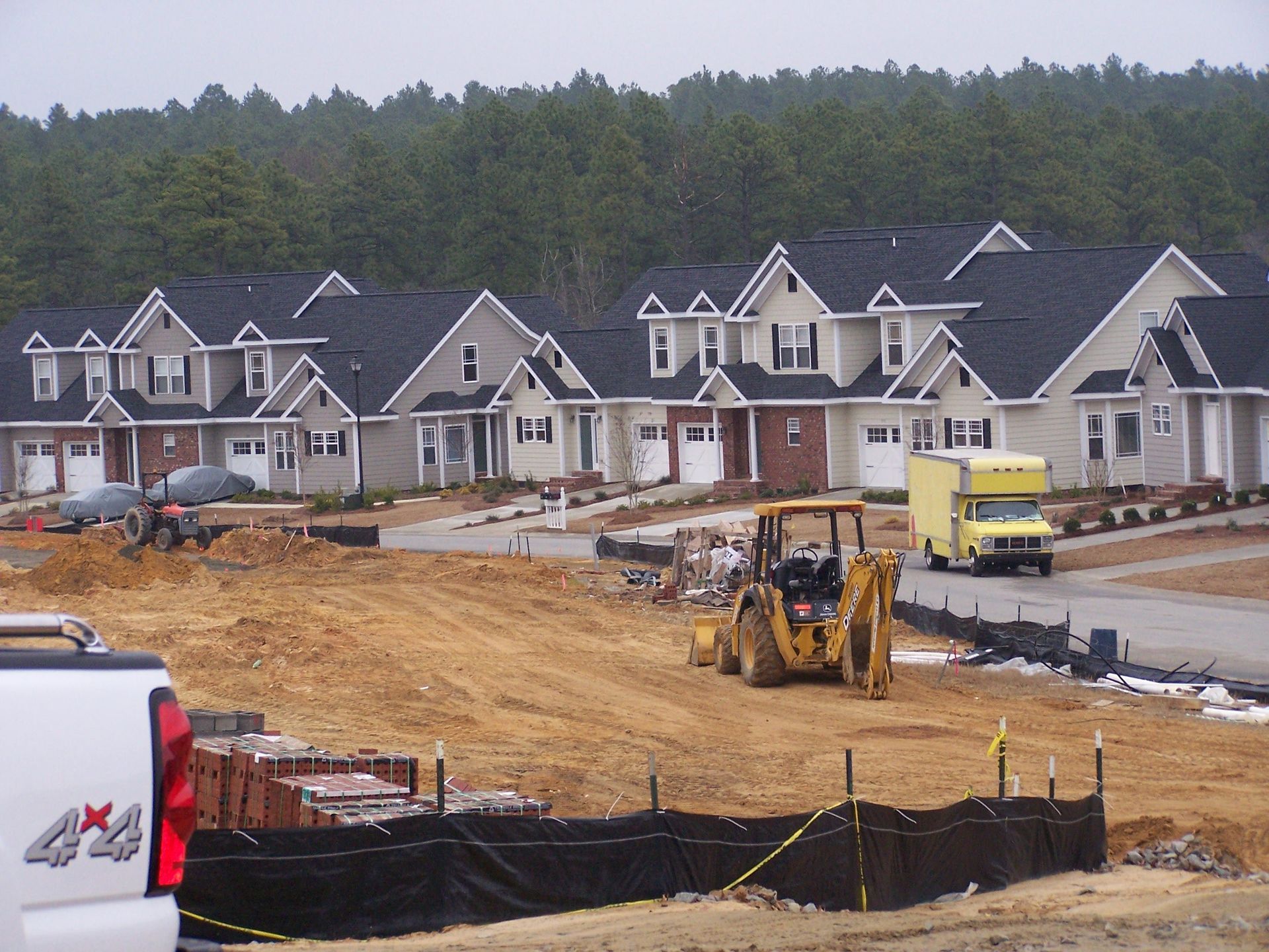 A 4x4 truck is parked in front of a construction site
