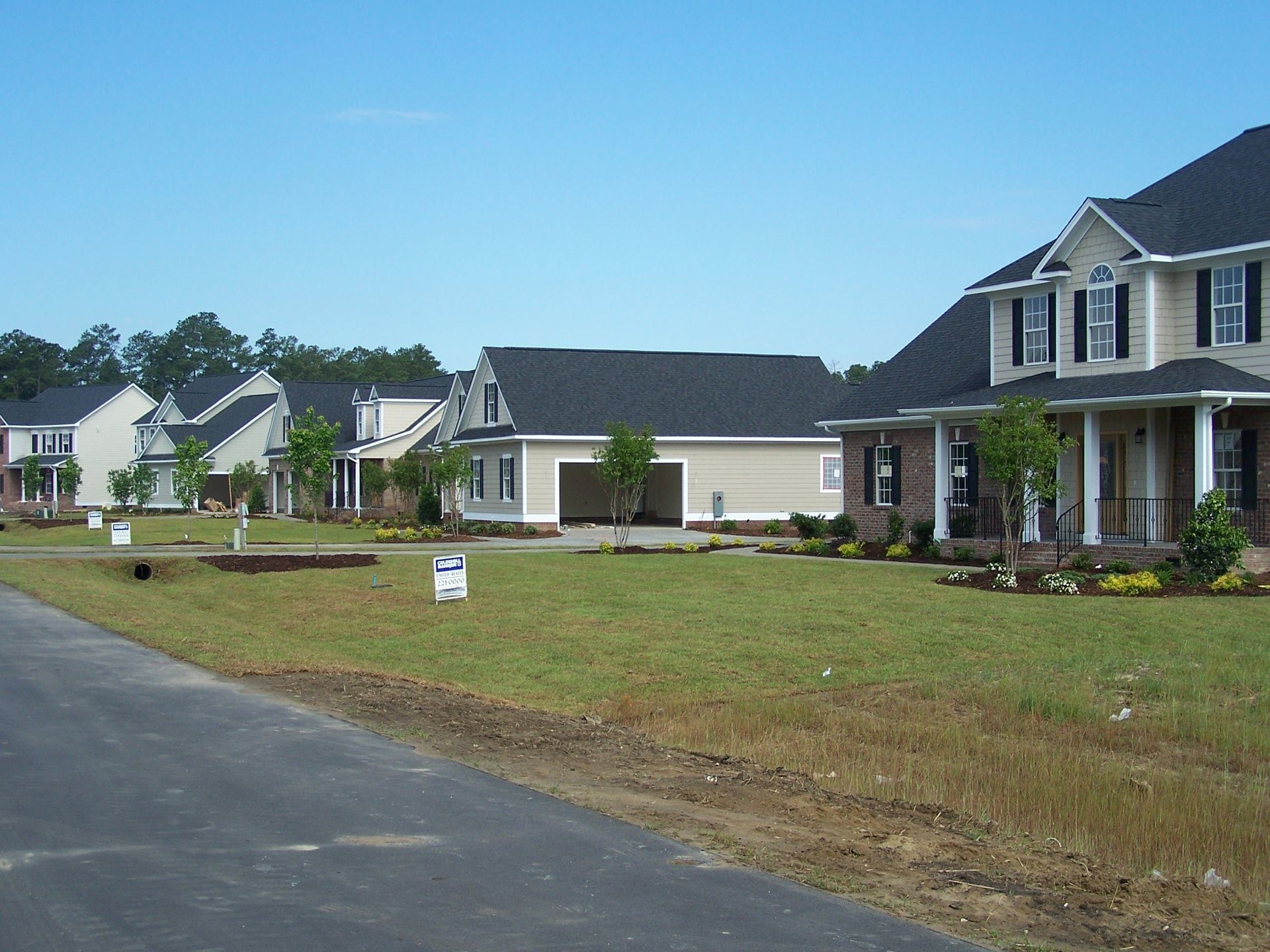 A row of houses in a residential area with a sign that says