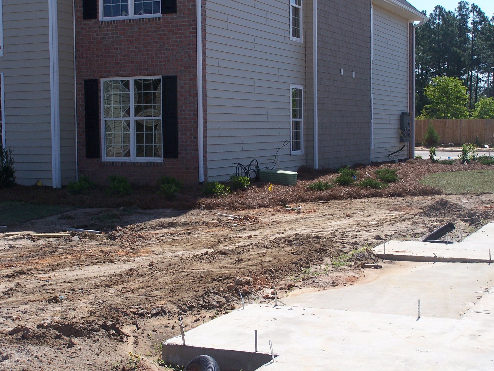 A house with a lot of dirt in front of it