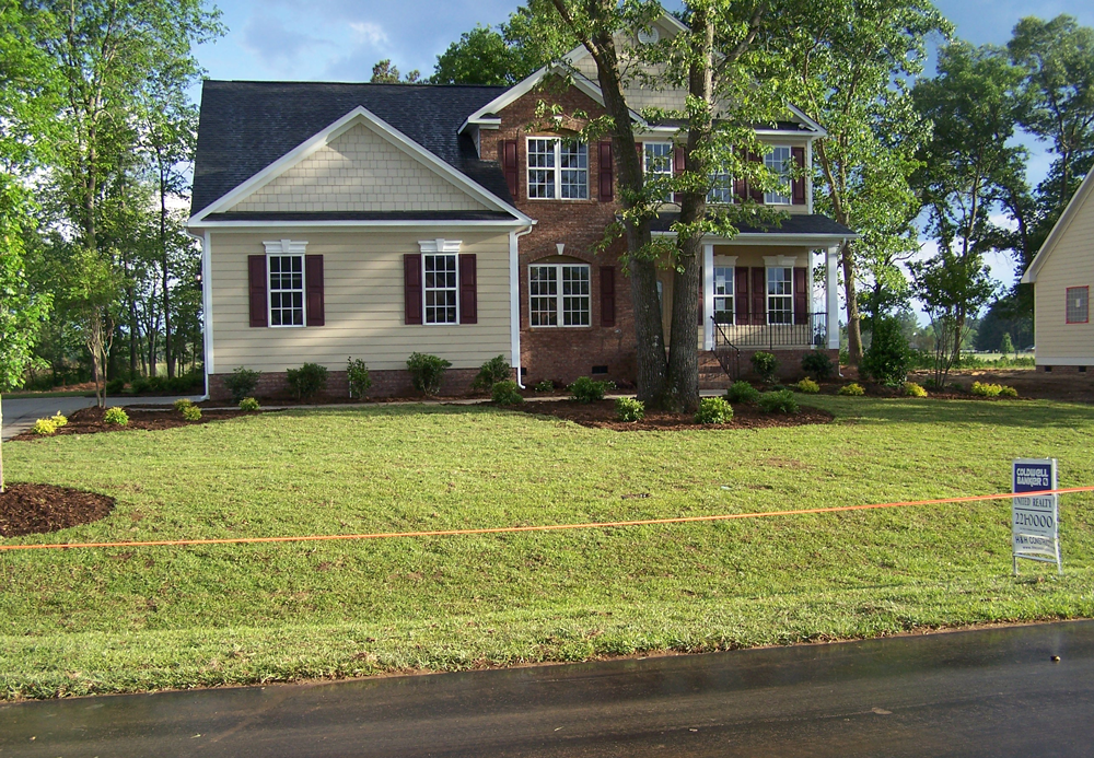 A house with a lot of grass in front of it