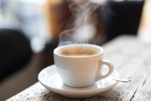 Woman Holding A Coffee — Gordonville, PA — The Village Cafe