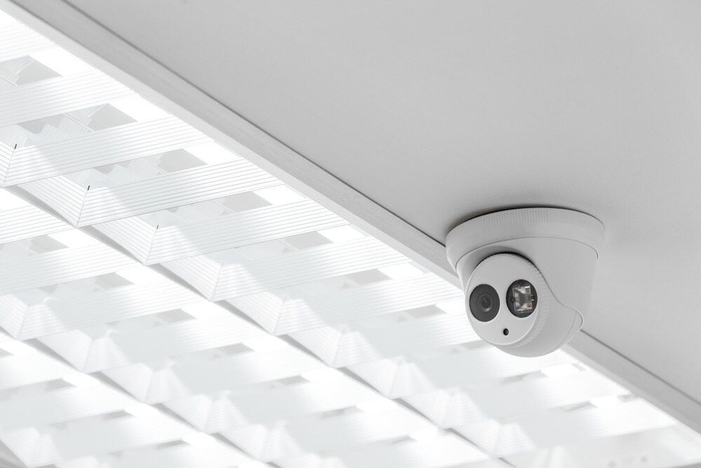 A Security Camera Is Mounted on The Ceiling of A Building — T.N. Locke Communications In Kirwan, QLD