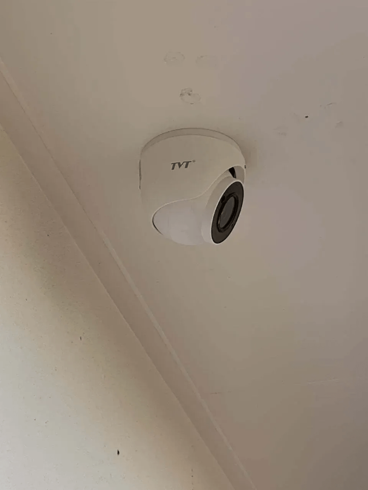 A Security Camera Is Mounted to The Ceiling of A Room — T.N. Locke Communications In Kirwan, QLD