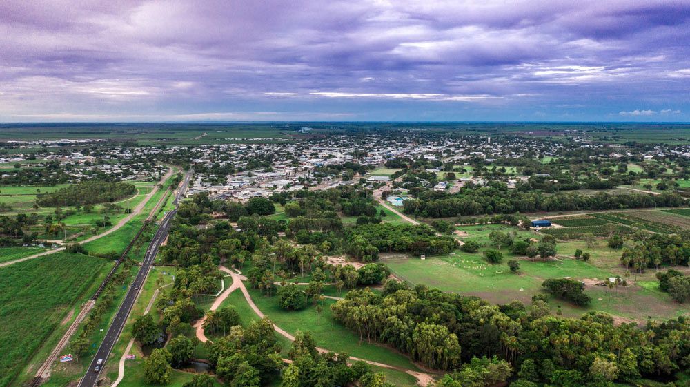 An Aerial View of a Small Town Surrounded by Trees and Fields — T.N. Locke Communications In Burdekin, QLD