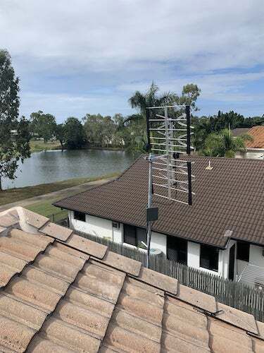 A Rooftop View of A House with A Lake in The Background — T.N. Locke Communications In Kirwan, QLD