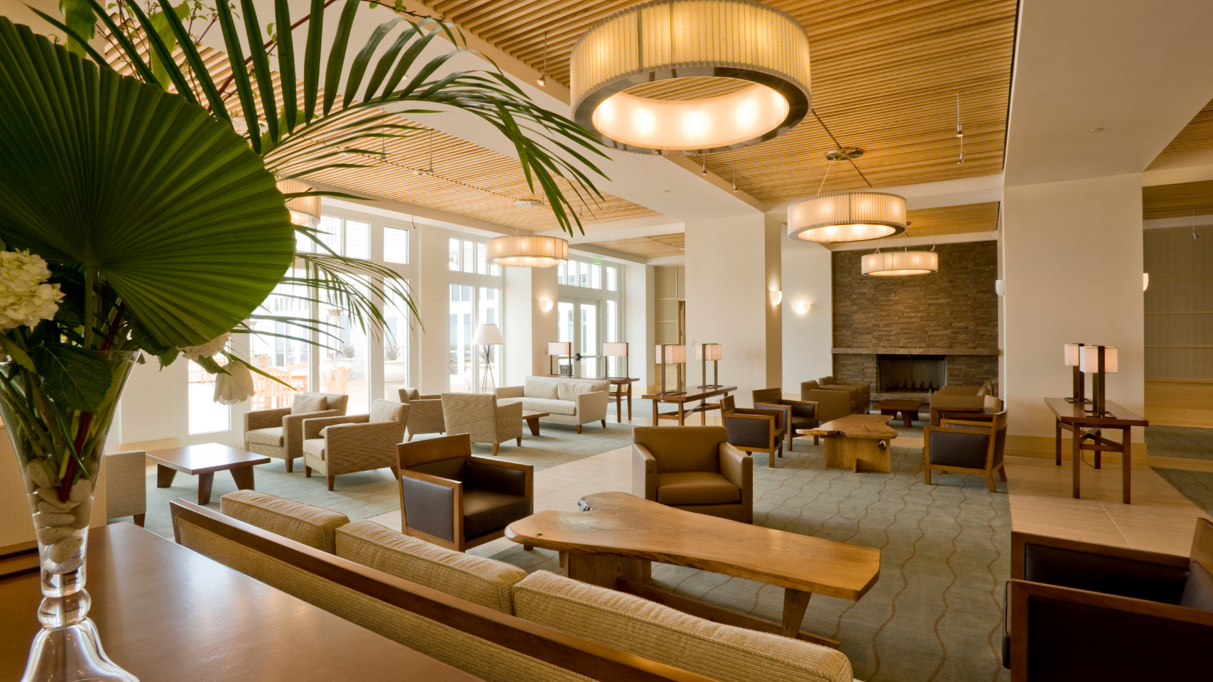 Bright modern hotel lobby with curved ceiling, lounge seating, and large windows
