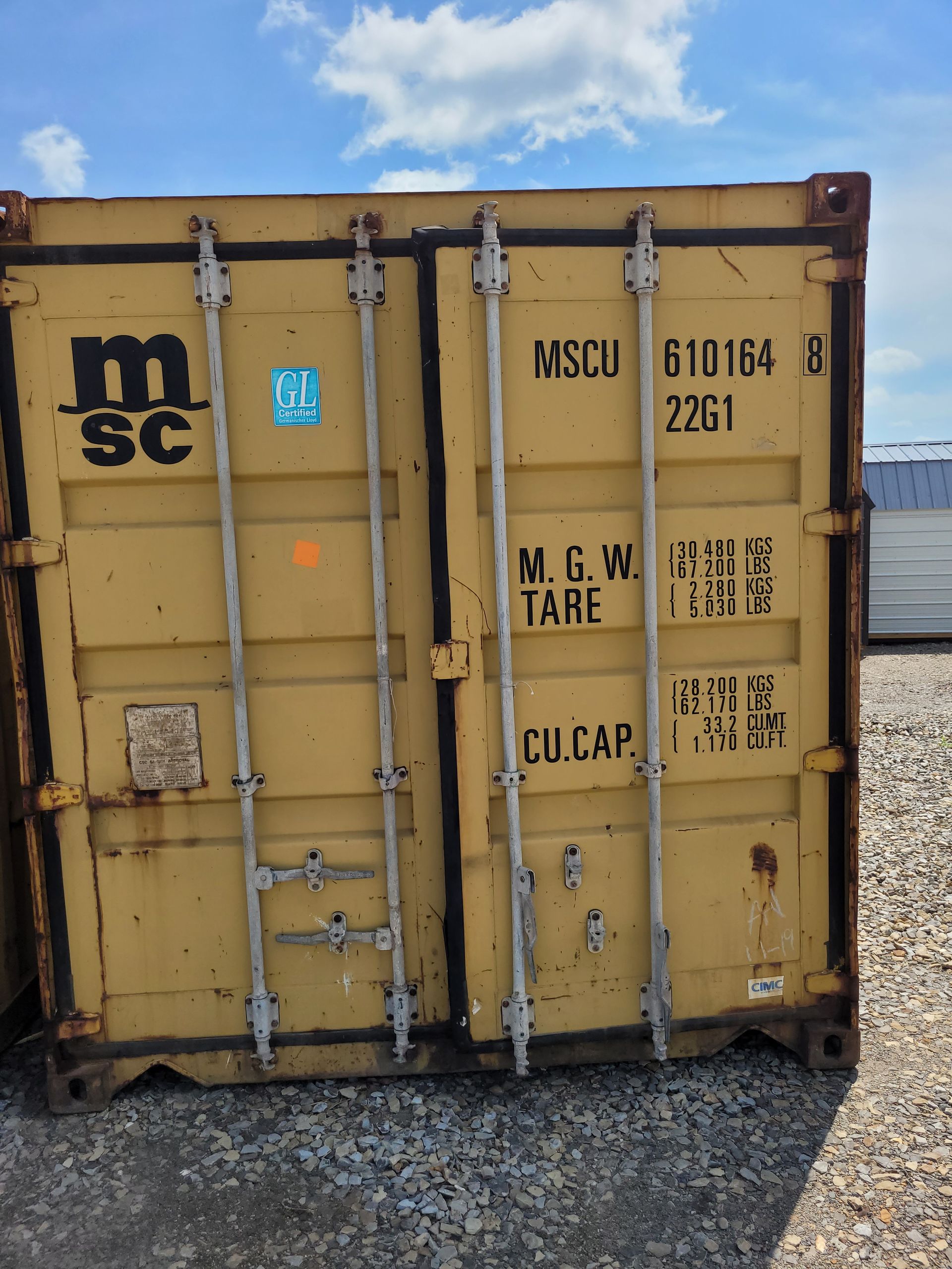 A yellow shipping container with mscu written on it
