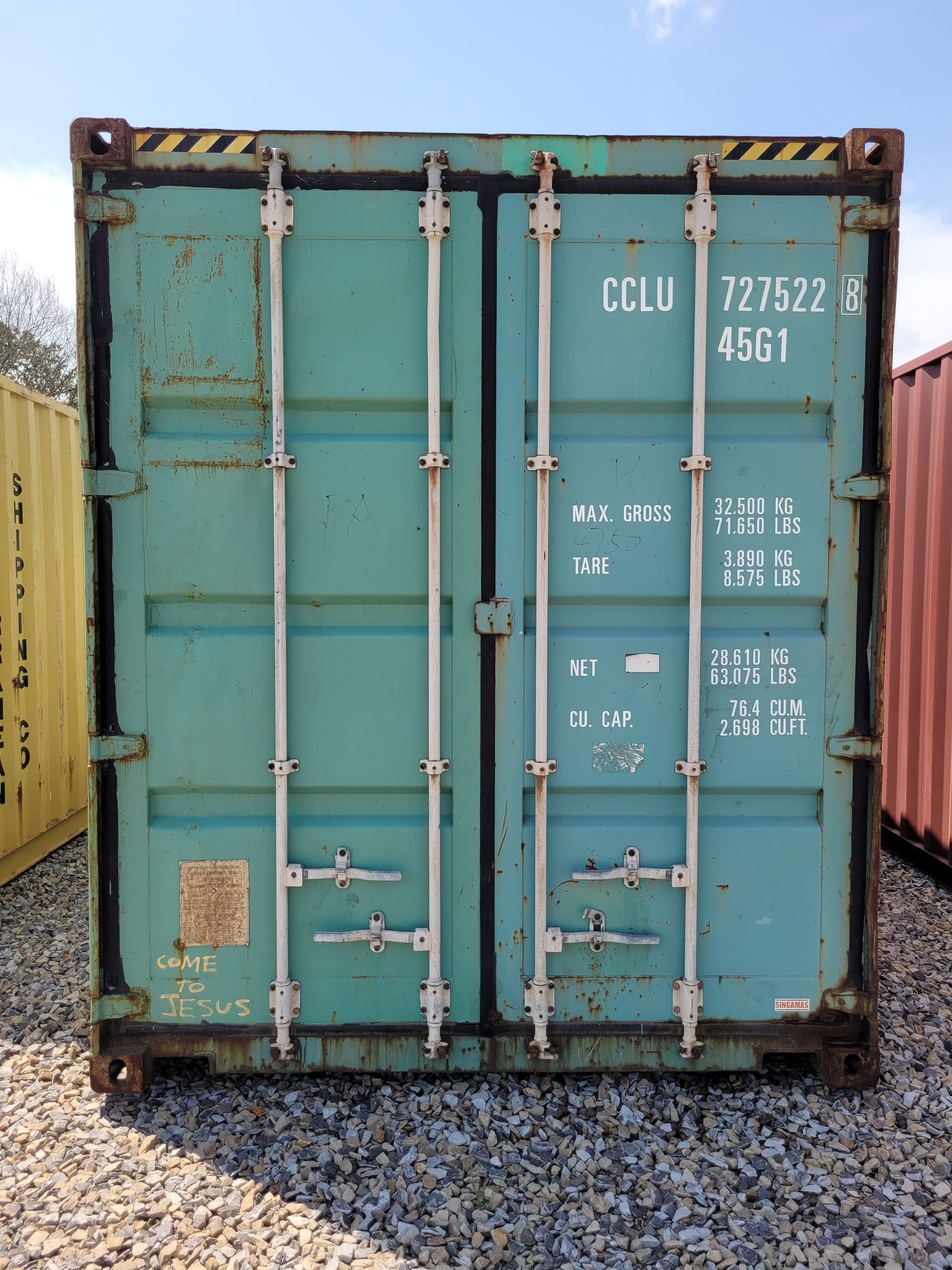 A blue shipping container with the numbers 771522 on it