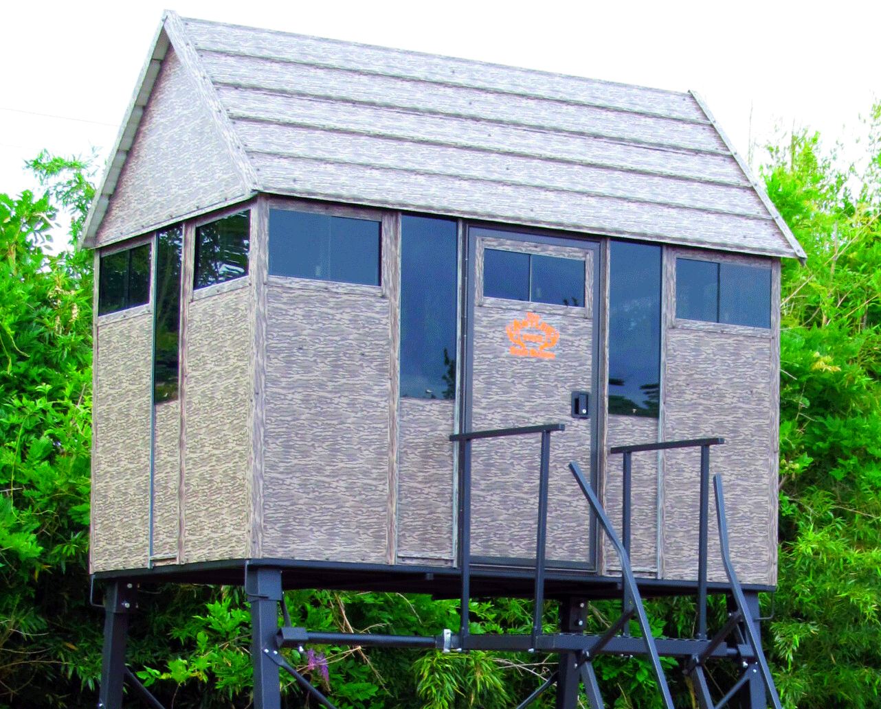Superior Outdoor Centers deer blinds
A small shed with a roof and stairs is surrounded by trees.