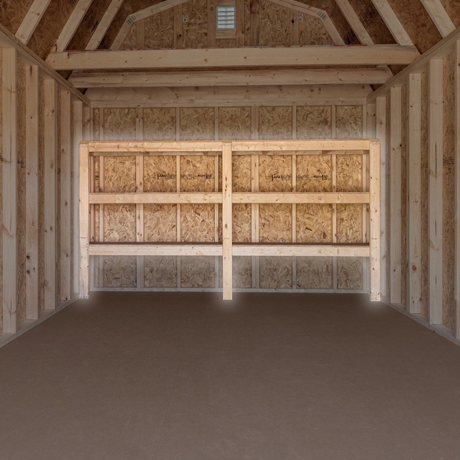 An empty wooden garage with shelves and a ceiling fan.