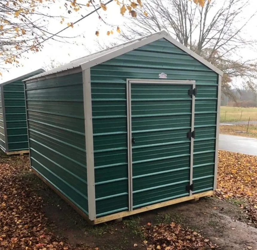 Superior Outdoor Centers metal barn A green shed with a white trim sits in the dirt