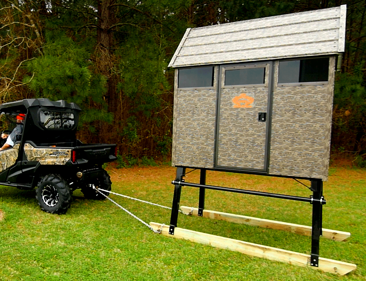 Superior Outdoor Centers deer blinds
A shed is being pulled by a atv in a grassy field.