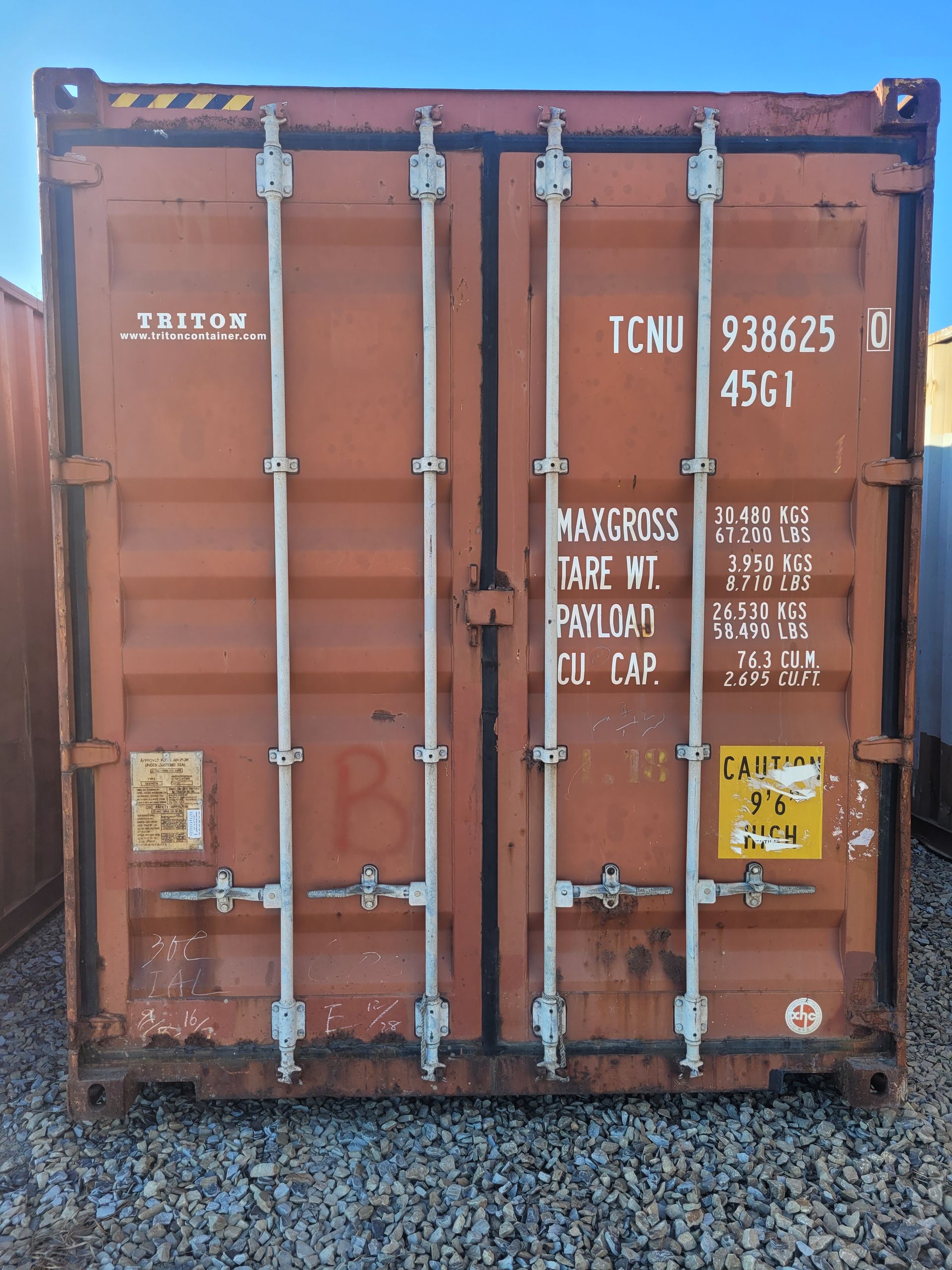 A brown shipping container with the letters tcnu on it