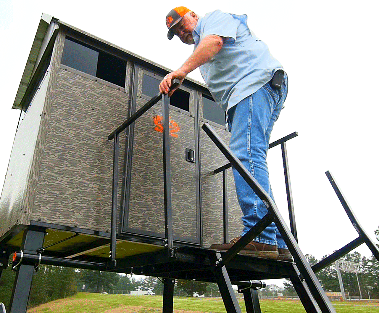 Superior Outdoor Centers deer blinds
A man is standing on a ladder next to a shed.