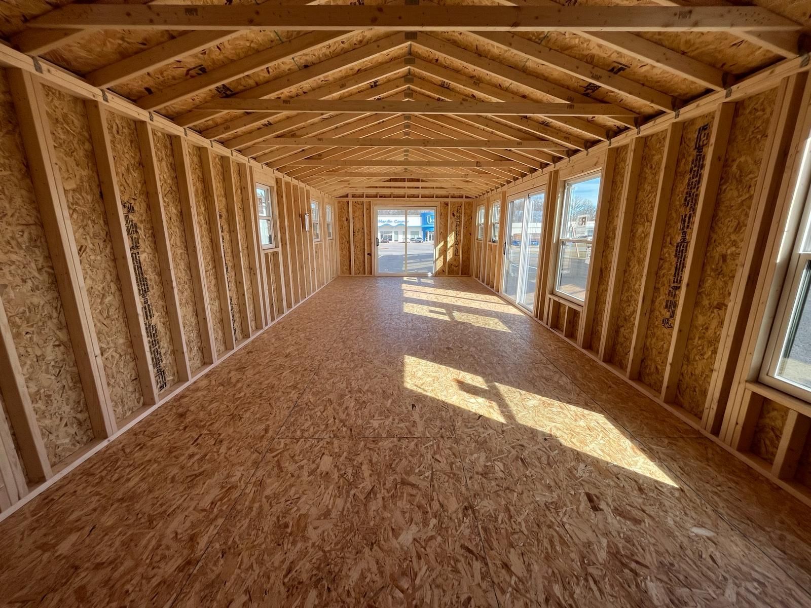 Superior Outdoor Centers  Tiny house interior A large empty room with wooden walls and a wooden floor.