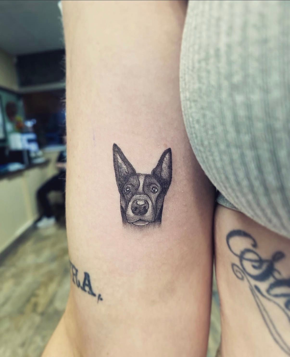 Small Black Dog Face Tattoo on an Upper Arm — Tattoo Inc Studio In Broadbeach, QLD