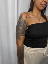 Woman in a Black One-shoulder Top and Beige Pants — Tattoo Inc Studio In Broadbeach, QLD