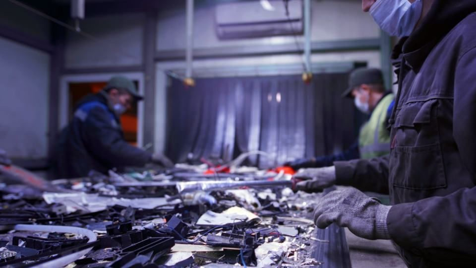 Man sorts garbage, electronics 