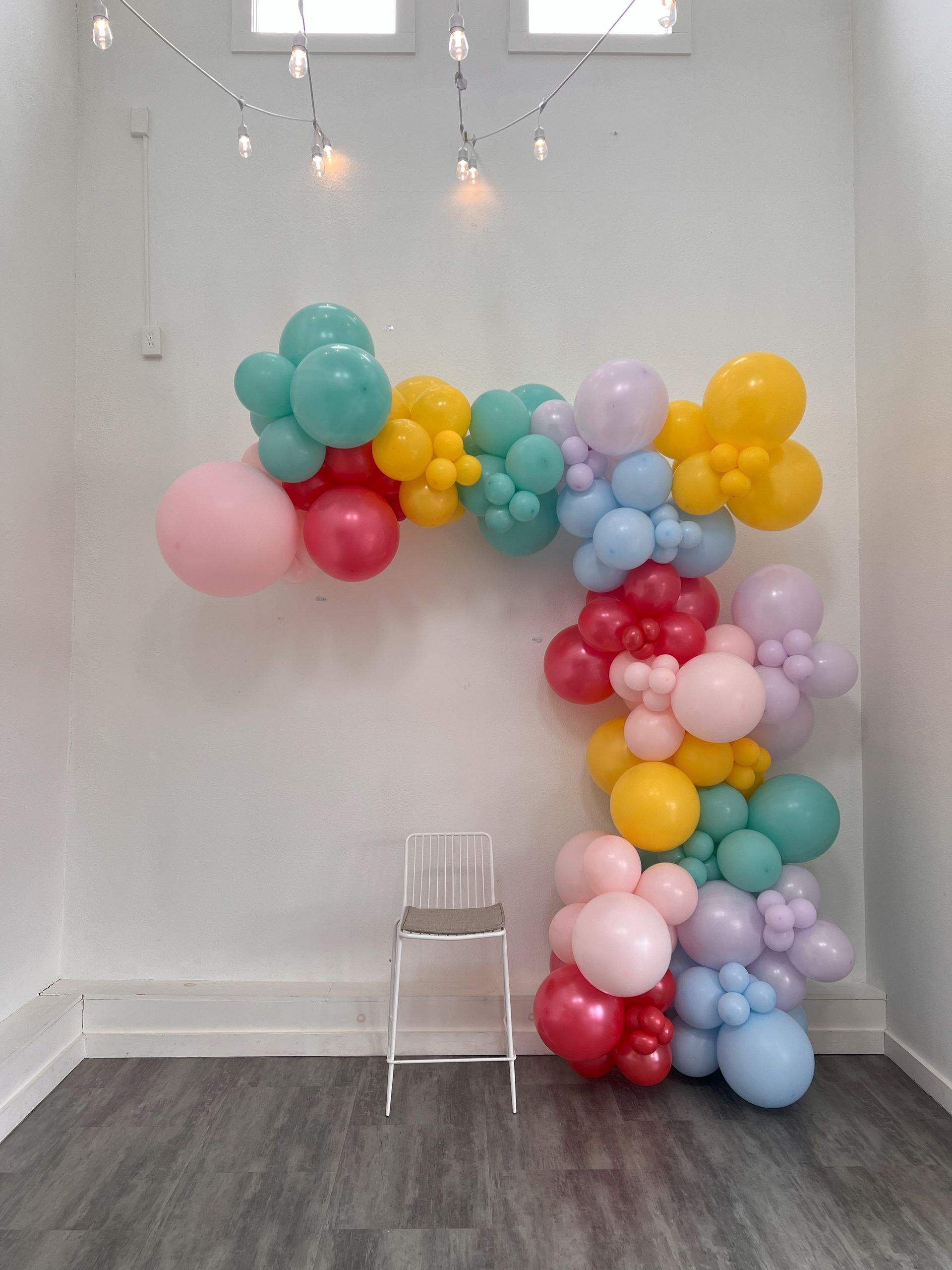 a room filled with balloons and a chair