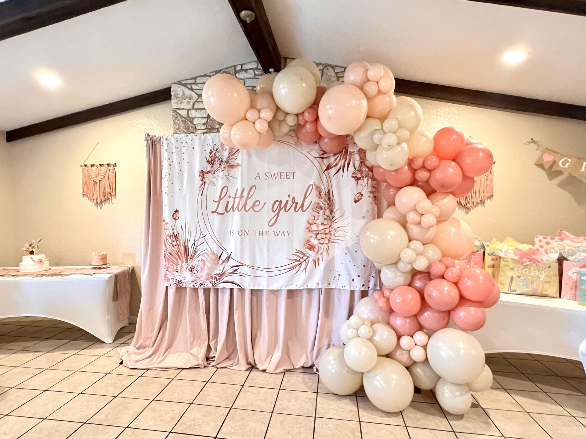 A room filled with balloons and a sign that says `` little girl ''.