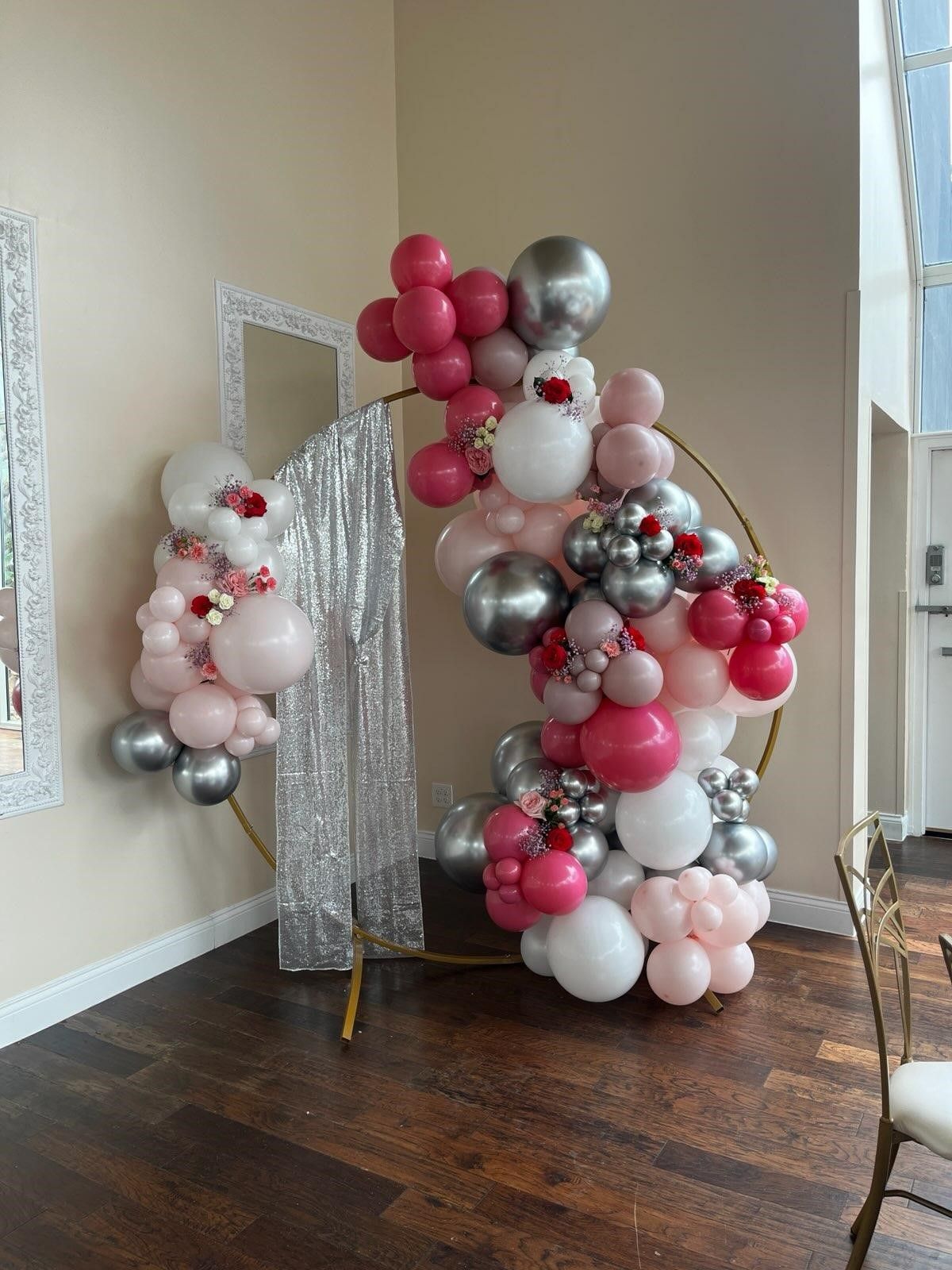 A room filled with balloons and a mirror.