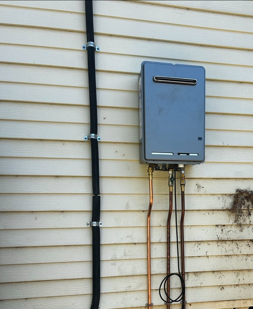 Utility Box and Cables Mounted on a House Exterior — SJ Moore Plumbing & Roofing in Tumut, NSW