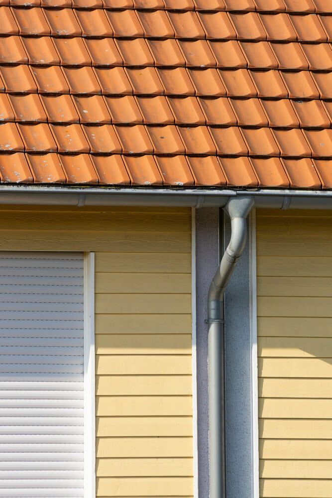 House Exterior With Orange Tiled Roof — SJ Moore Plumbing & Roofing in Wagga Wagga, NSW 