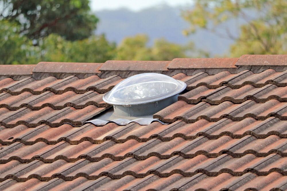 White Skylight Dome on a Reddish-brown Tiled Roof — SJ Moore Plumbing & Roofing in Tumut, NSW