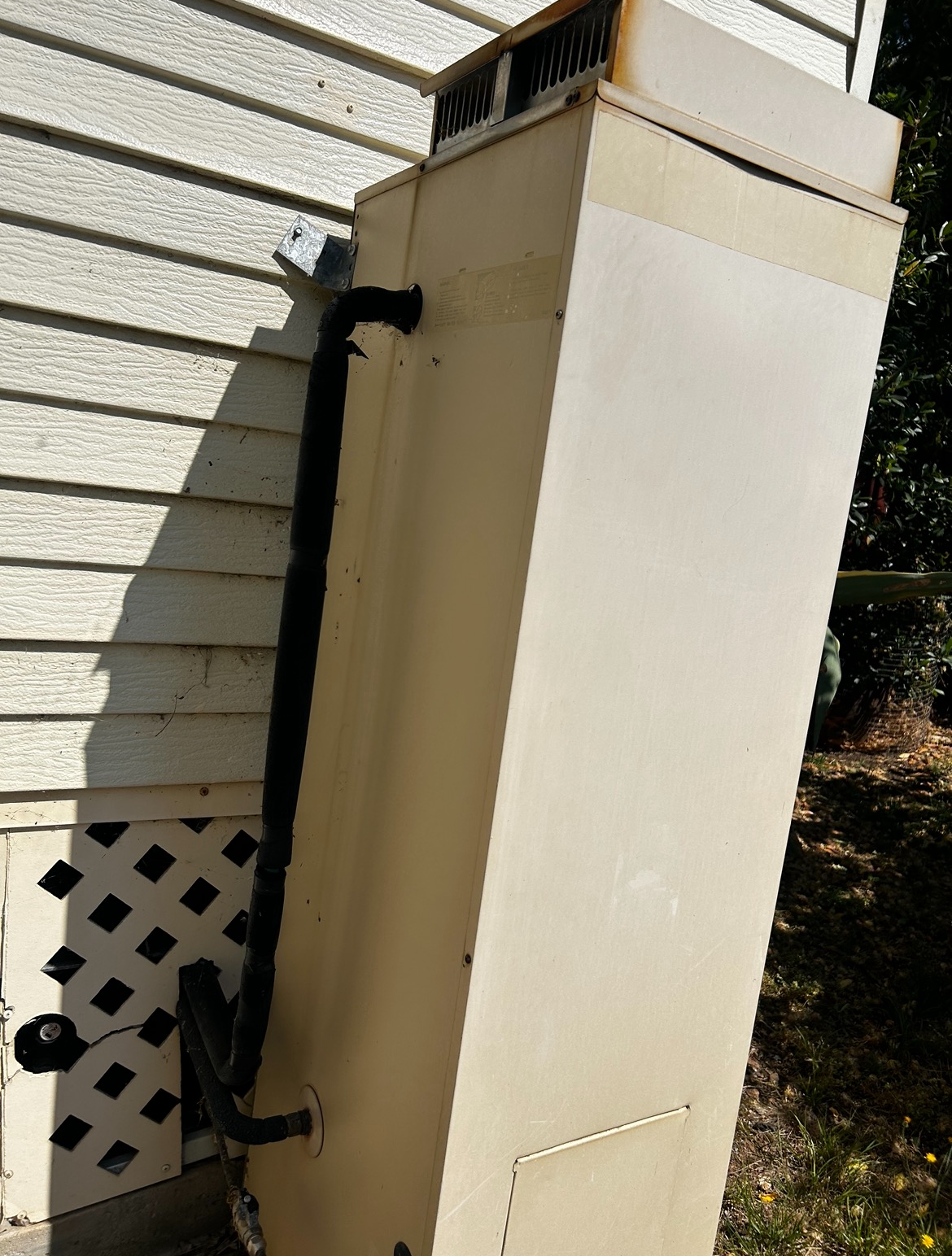 Tall Beige Utility Cabinet Beside a House Wall — SJ Moore Plumbing & Roofing in Tumut, NSW 