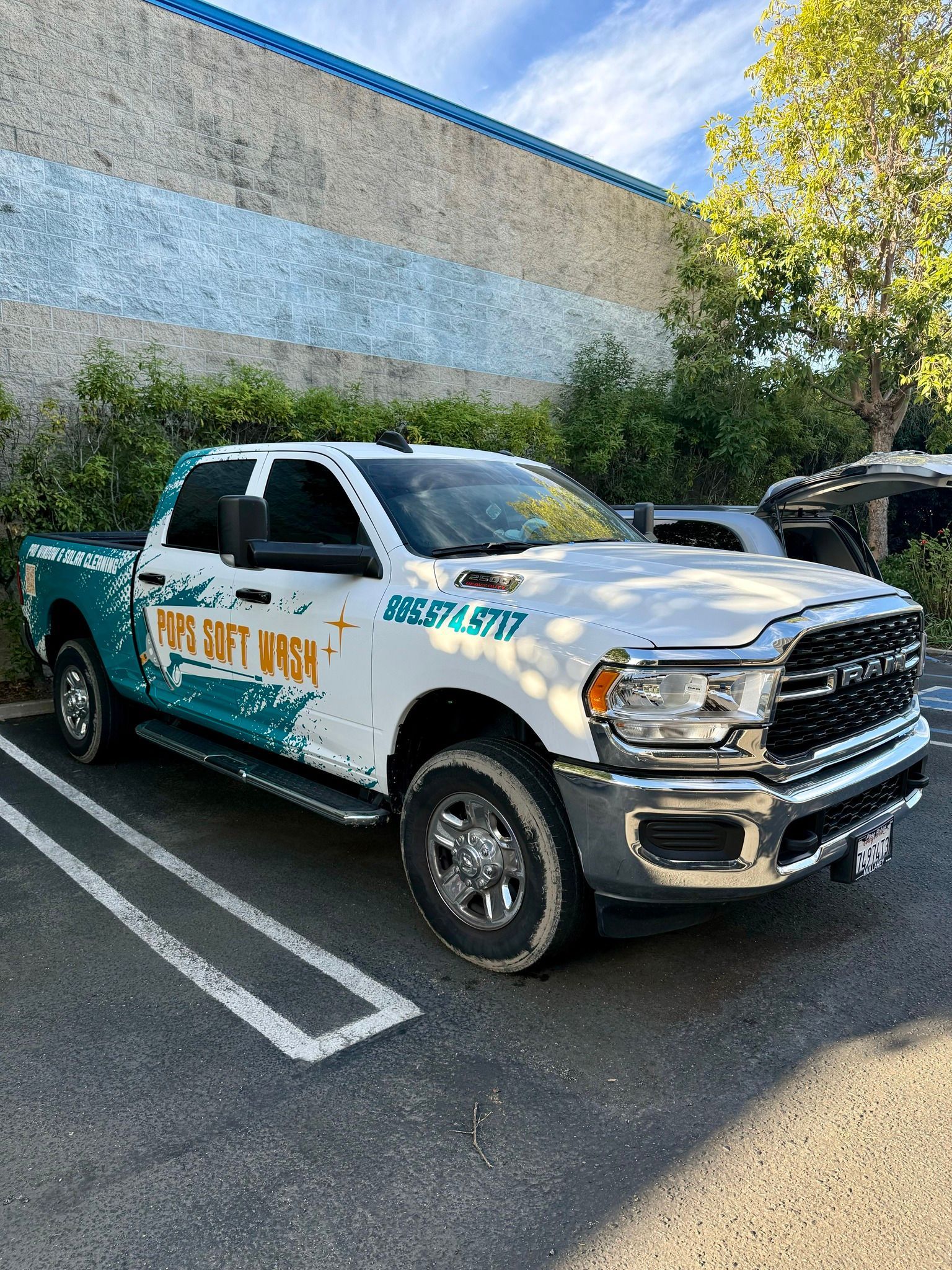 White sheriff pickup truck parked in a lot beside a building and trees