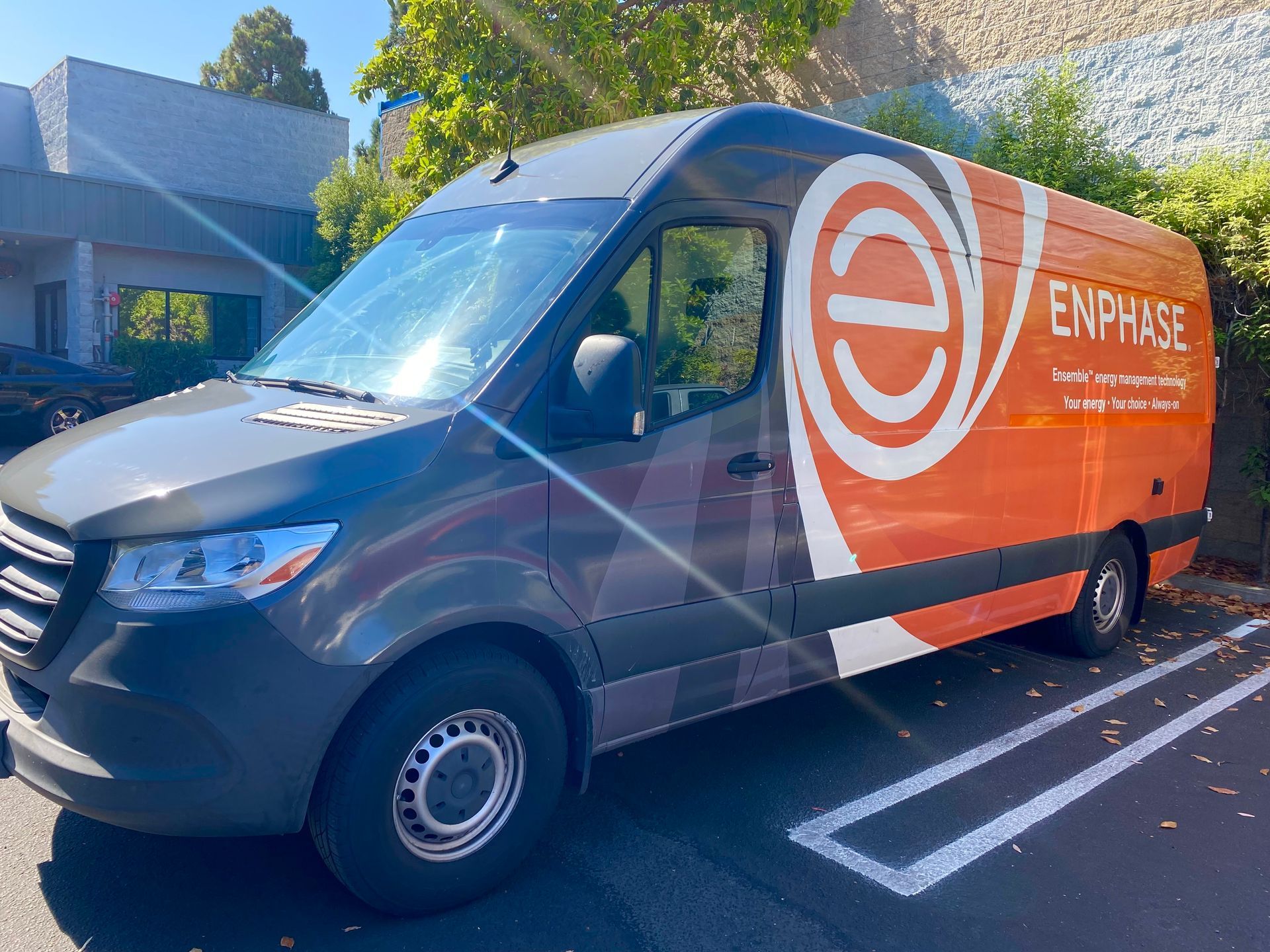 Orange Enterprise van parked in a lot, with white logo and text on the side.