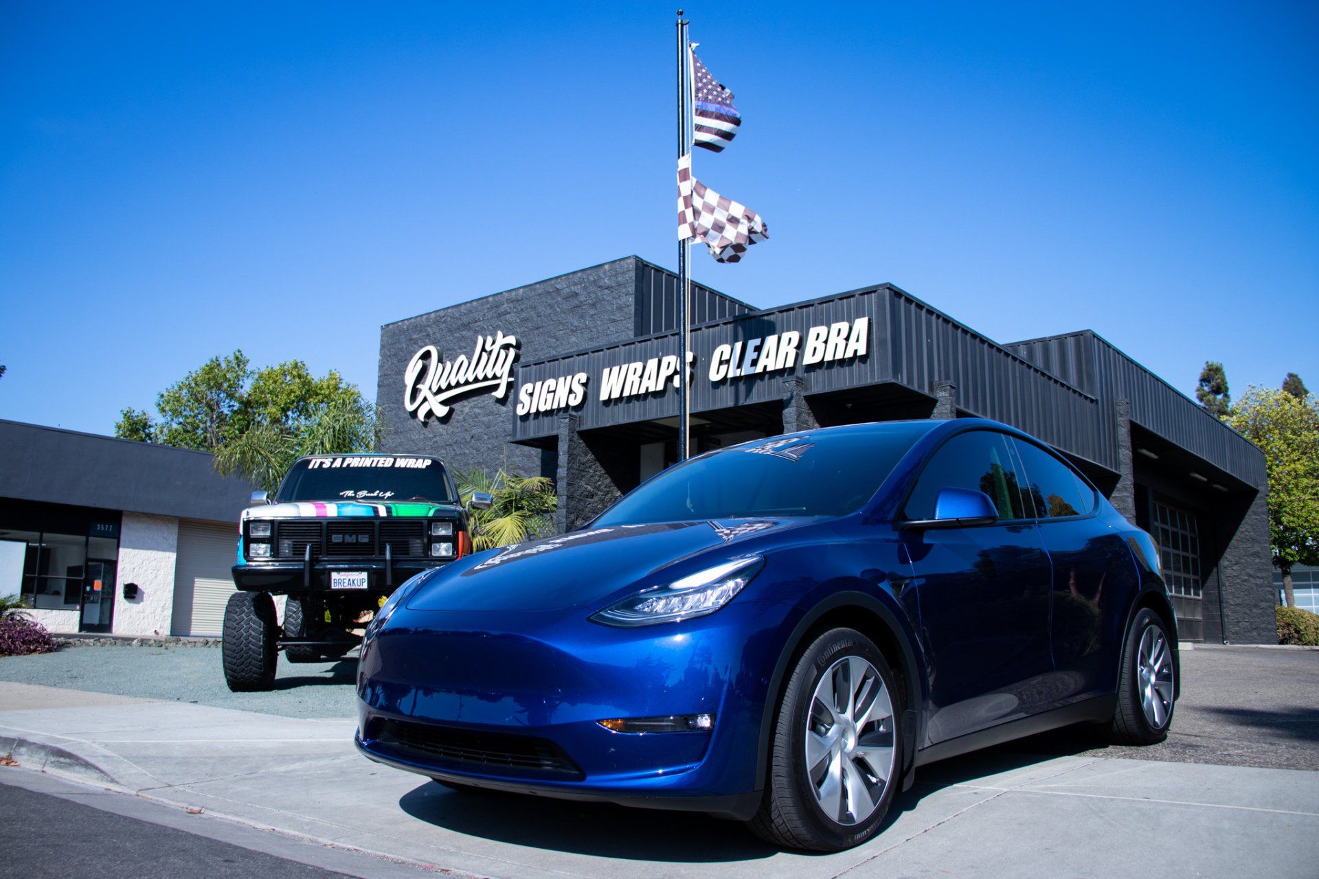 Blue Tesla Model Y at the Quality Tinting & Signs shop in San Luis Obispo — Tesla window tint, PPF & wraps