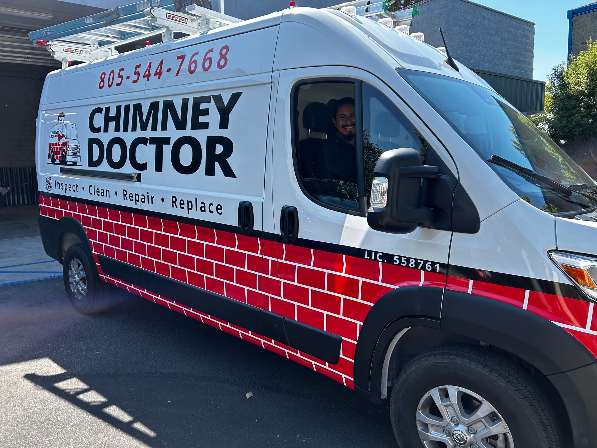 White Chimney Doctor service van with red brick design parked outdoors on a sunny street.