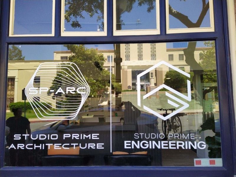 Storefront windows with Studio Prime Architecture and Studio Prime Engineering logos and signage