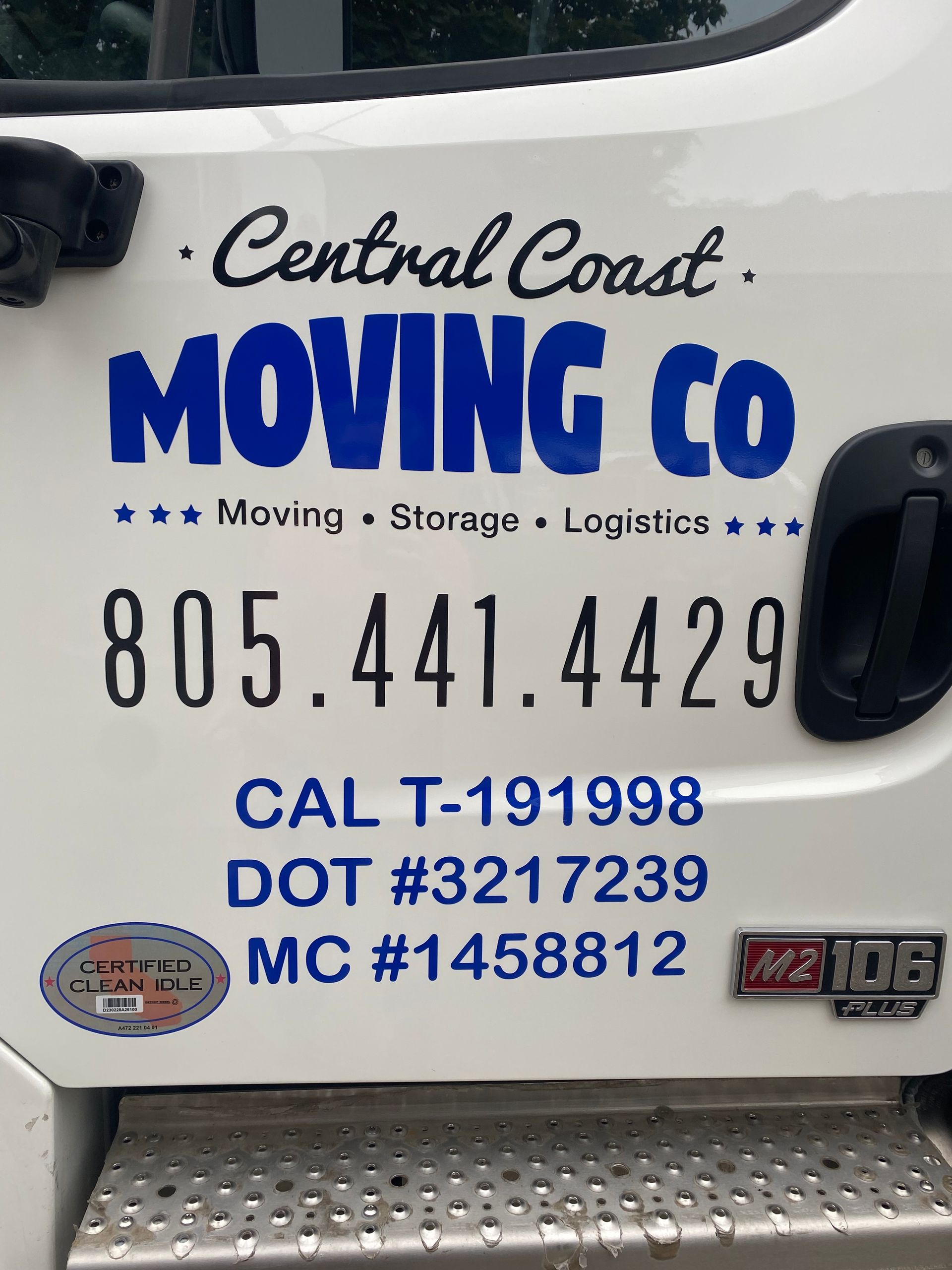 Side of white Central Coast Moving Co. truck with blue logo, phone number, and license details