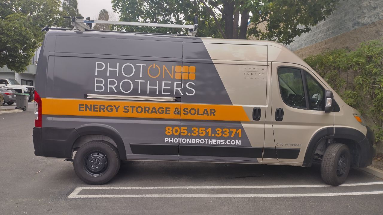 Photon Brothers energy storage and solar van parked on a street, with company branding on the side.