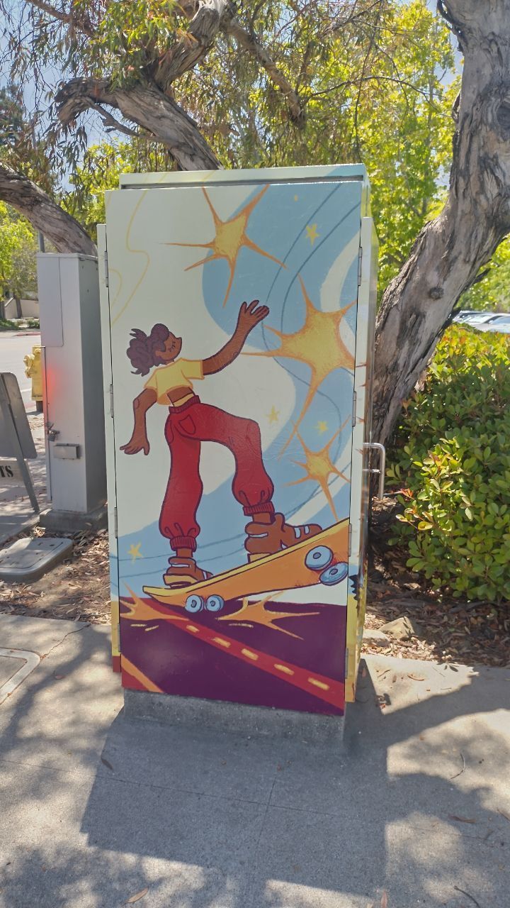 Colorful utility box mural of a skateboarder in red pants with an abstract sky and palm trees.