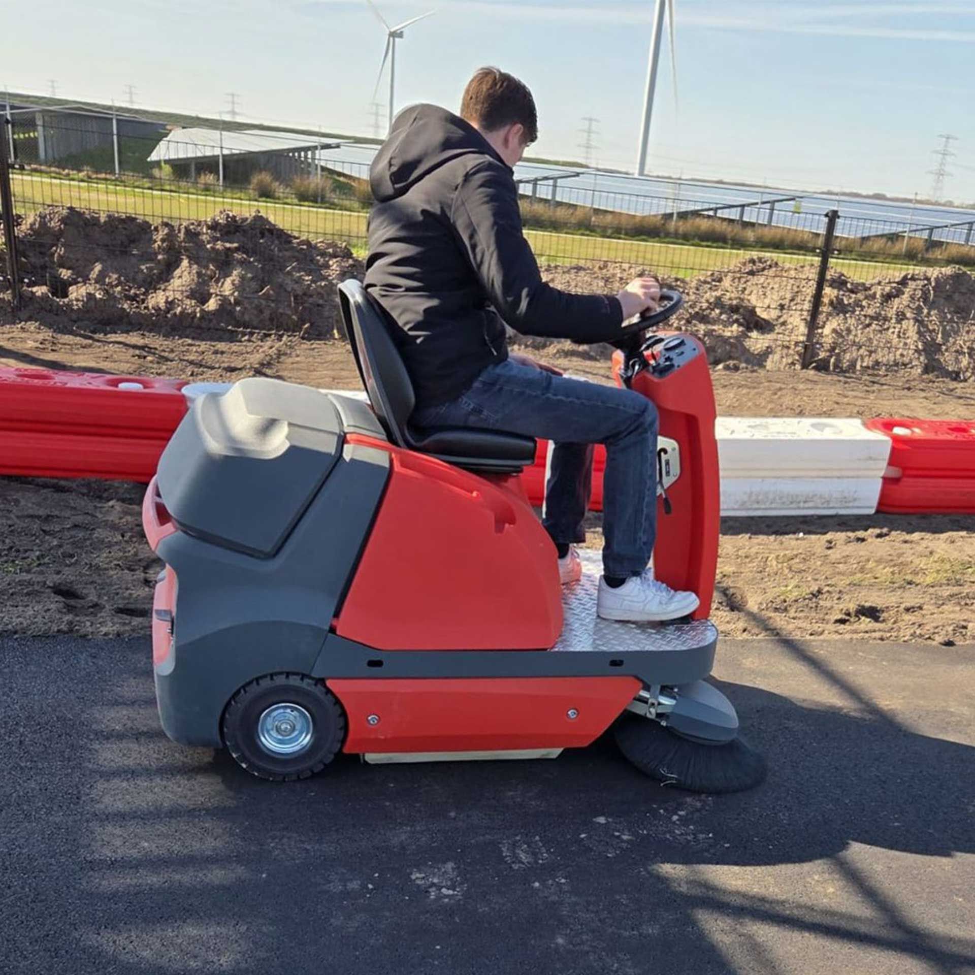 Meclean ride-on sweeper BUSTER 1150 sweeping on kart track