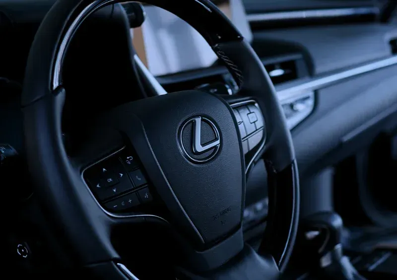 Lexus steering wheel and dashboard in a dark car interior