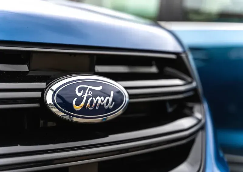 Close-up of a blue Ford car grille with the Ford emblem visible