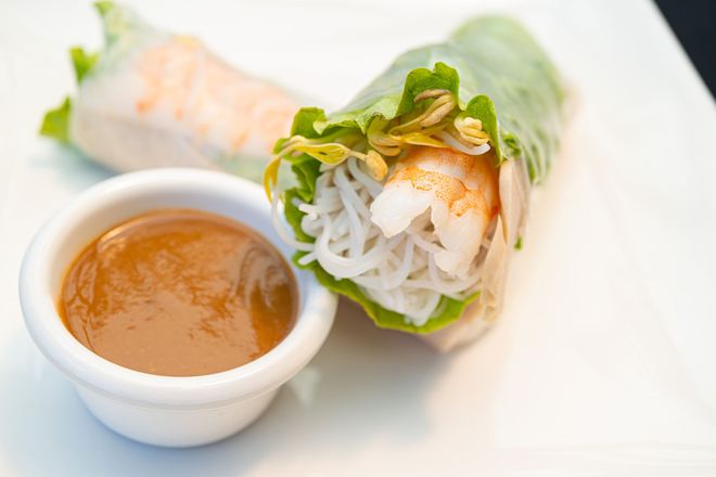 Golden fried chicken bites on a slate plate with lettuce garnish and dipping sauce